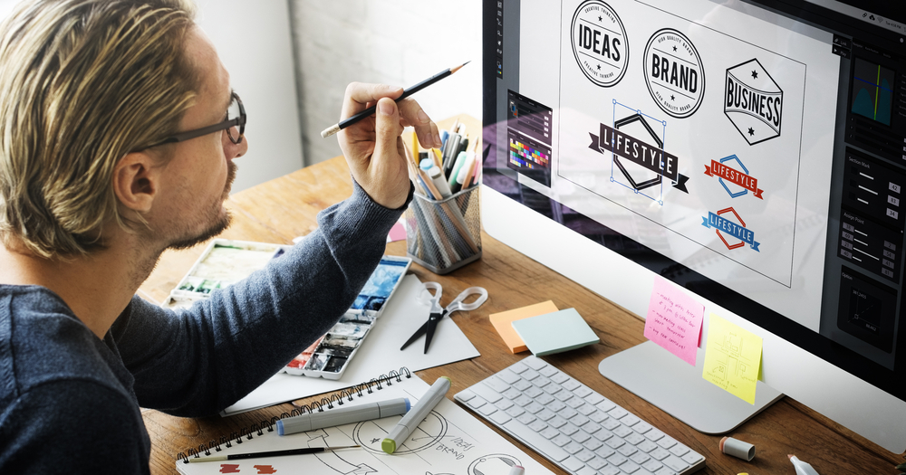 A brand specialist choosing a brand logo in his computer. Marketing Agency's Approach to Concept Logo Design.