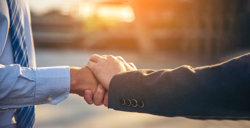 Handshake Between Businessmen, Symbolizing Trust and Partnership, a Core Value of a Marketing Agency in New Orleans